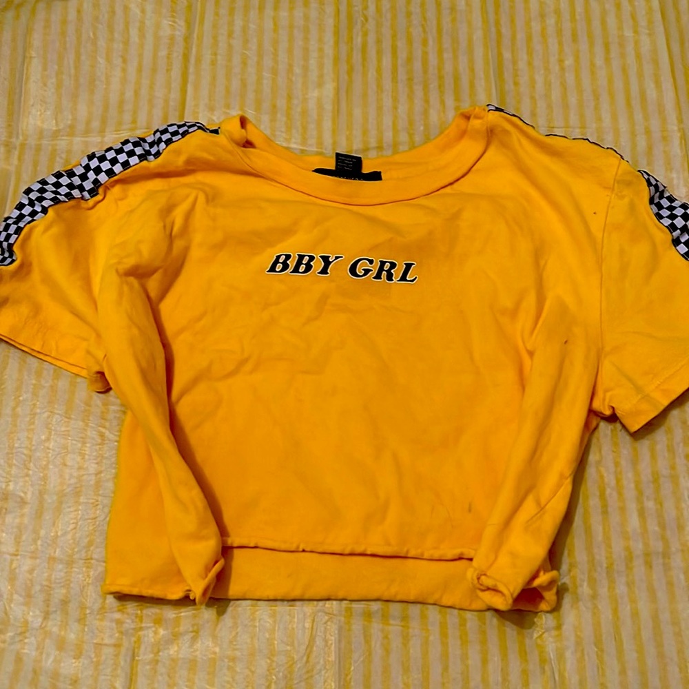 Checkered yellow crop top with print on it